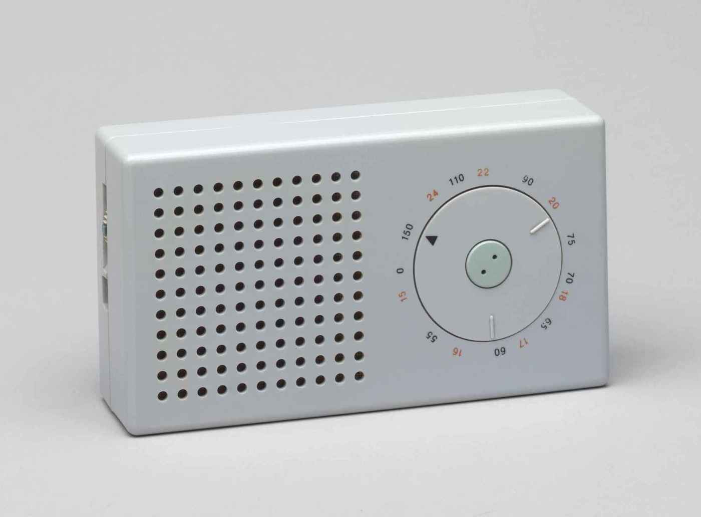 The iconic Braun T3 pocket transistor radio, designed by Dieter Rams (195867ya; MoMA photo); though somewhat faded, the red (one of only 3 colors on the device) numerals still clearly denote longwave radio frequencies (black for medium wave length). It strikingly resembles the Apple iPod, which, however, is all-white.